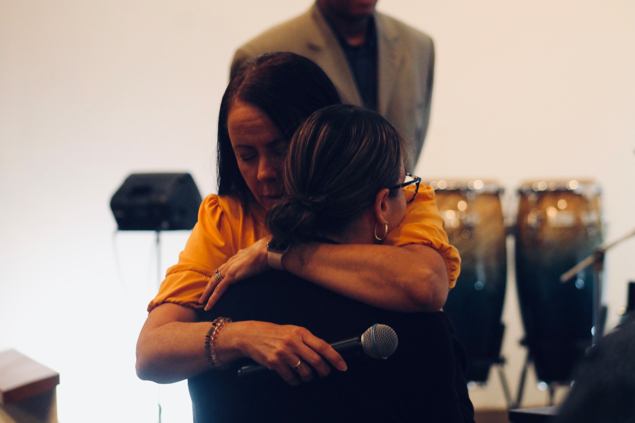 Two women embracing during a Fuego Church service